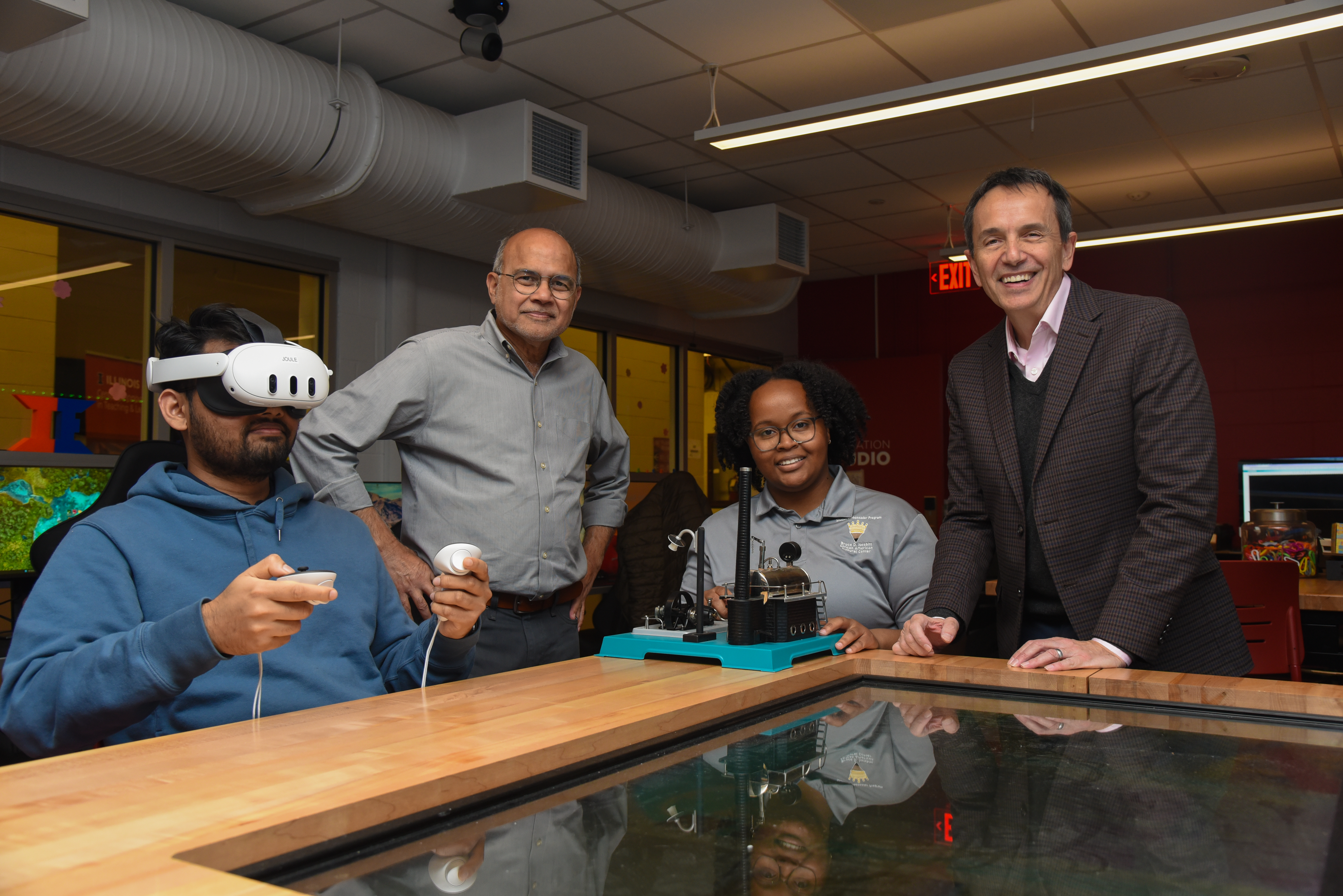 Professors Rizwan Uddin (standing, left) and Leon Liebenberg (standing, right) in the Illinois Innovation Studio